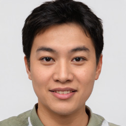 Joyful asian young-adult male with short  brown hair and brown eyes