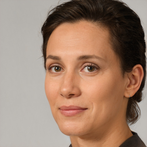 Joyful white adult female with medium  brown hair and brown eyes