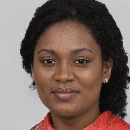 Joyful black adult female with medium  black hair and brown eyes