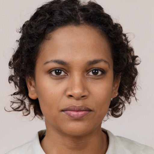Neutral black young-adult female with medium  brown hair and brown eyes