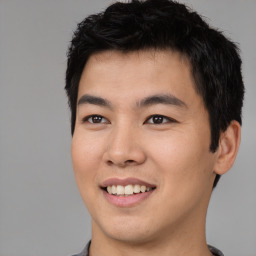 Joyful asian young-adult male with short  black hair and brown eyes