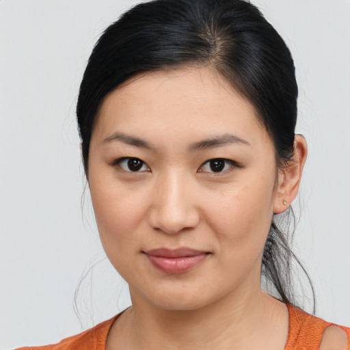 Joyful asian young-adult female with medium  black hair and brown eyes