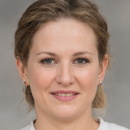 Joyful white young-adult female with medium  brown hair and grey eyes