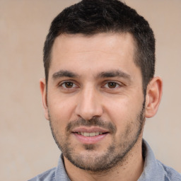 Joyful white young-adult male with short  black hair and brown eyes