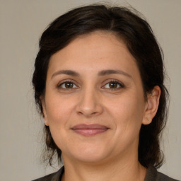 Joyful white adult female with medium  brown hair and brown eyes