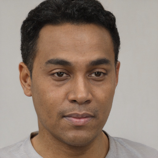 Neutral latino young-adult male with short  black hair and brown eyes