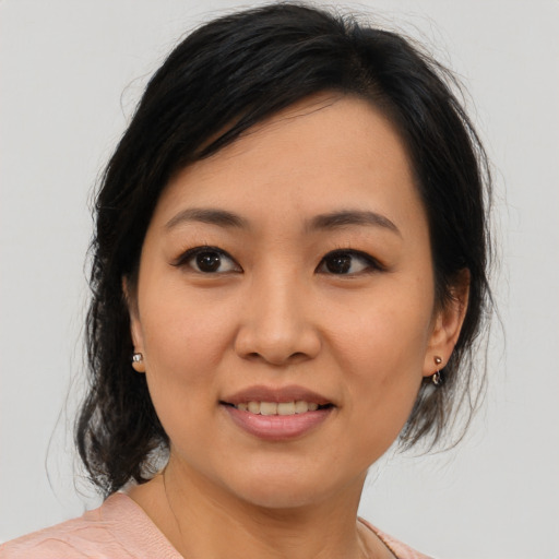 Joyful asian young-adult female with medium  brown hair and brown eyes