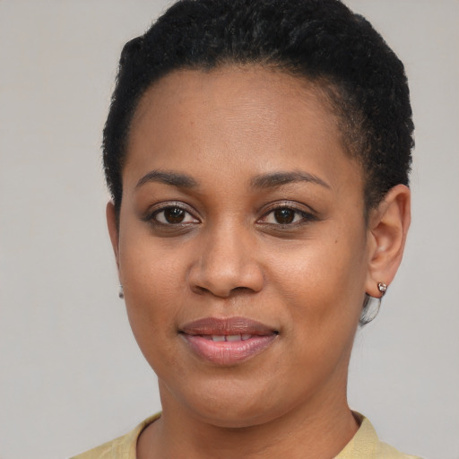 Joyful latino young-adult female with short  black hair and brown eyes