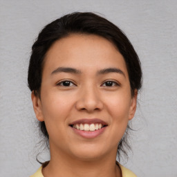 Joyful white young-adult female with medium  brown hair and brown eyes