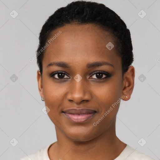 Joyful black young-adult female with short  black hair and brown eyes