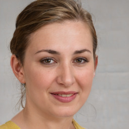 Joyful white young-adult female with medium  brown hair and blue eyes