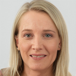 Joyful white young-adult female with long  brown hair and blue eyes