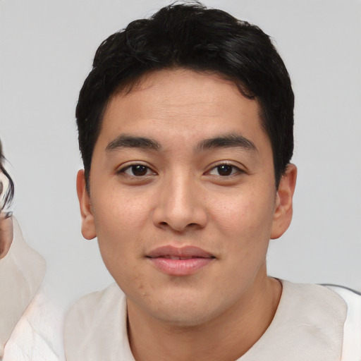 Joyful white young-adult male with short  black hair and brown eyes