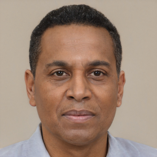 Joyful black adult male with short  brown hair and brown eyes