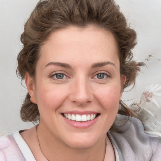 Joyful white young-adult female with medium  brown hair and blue eyes