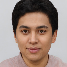 Joyful latino young-adult male with short  brown hair and brown eyes