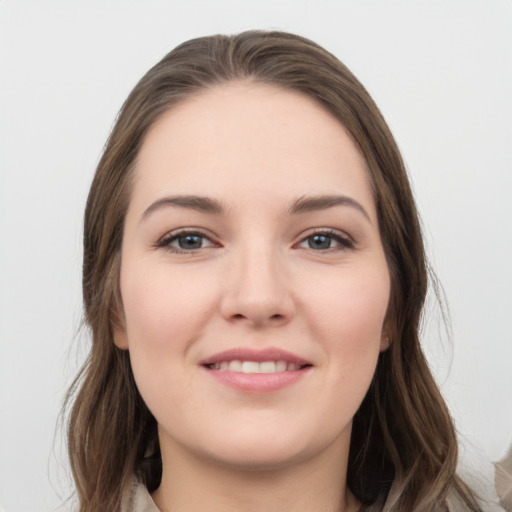 Joyful white young-adult female with long  brown hair and grey eyes