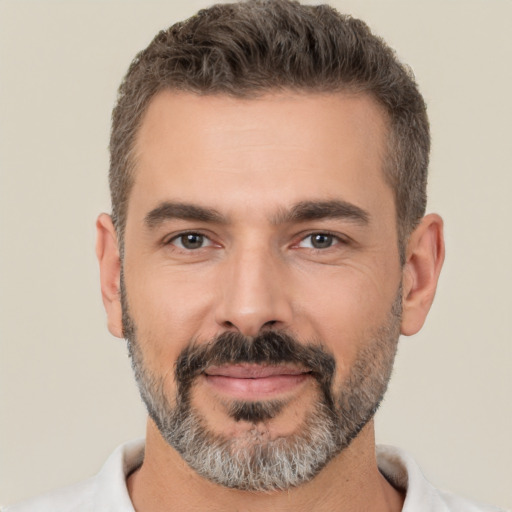 Joyful white adult male with short  brown hair and brown eyes