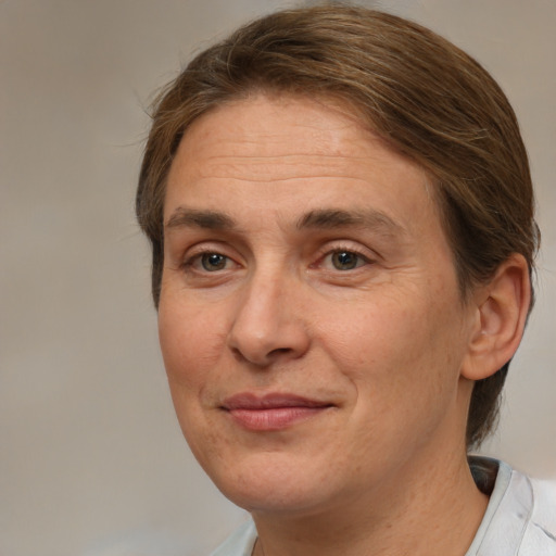 Joyful white adult male with medium  brown hair and brown eyes