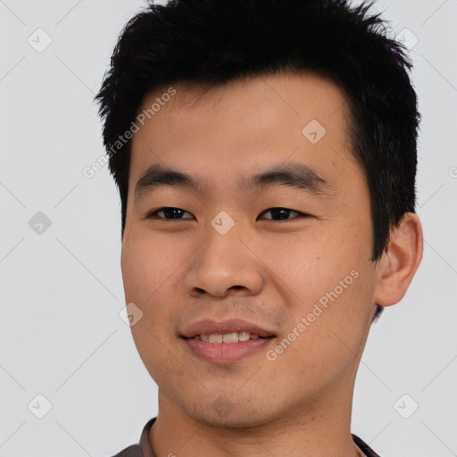 Joyful asian young-adult male with short  black hair and brown eyes