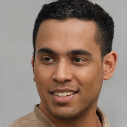 Joyful latino young-adult male with short  black hair and brown eyes