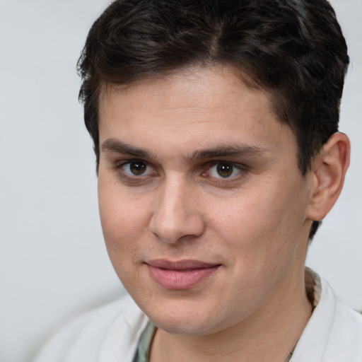 Joyful white young-adult male with short  brown hair and brown eyes