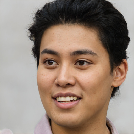 Joyful latino young-adult male with short  brown hair and brown eyes