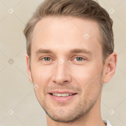 Joyful white adult male with short  brown hair and brown eyes