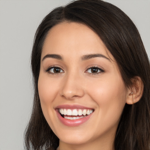 Joyful white young-adult female with long  brown hair and brown eyes