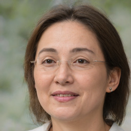 Joyful white adult female with medium  brown hair and brown eyes