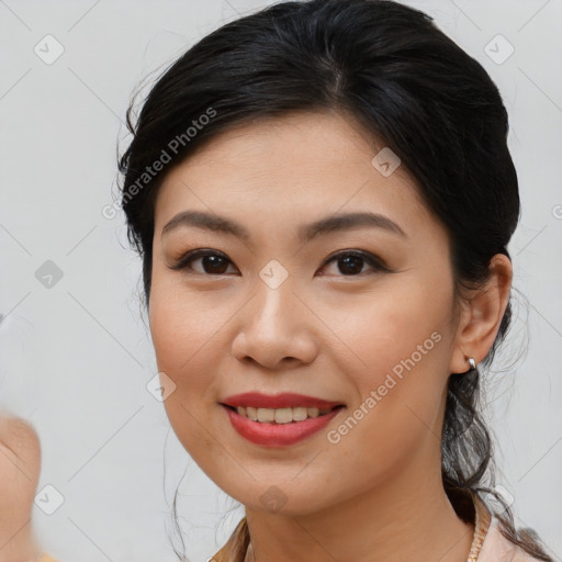 Joyful asian young-adult female with medium  brown hair and brown eyes