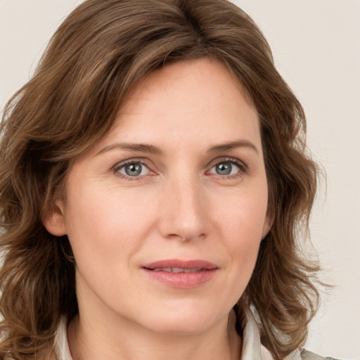 Joyful white young-adult female with medium  brown hair and green eyes