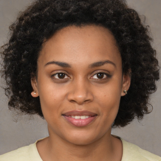 Joyful black young-adult female with medium  brown hair and brown eyes