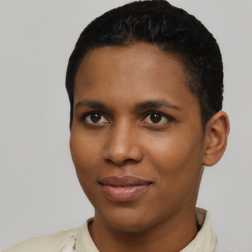 Joyful black young-adult female with short  black hair and brown eyes