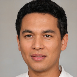 Joyful white young-adult male with short  black hair and brown eyes