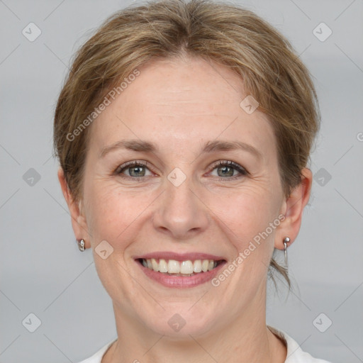 Joyful white adult female with medium  brown hair and grey eyes