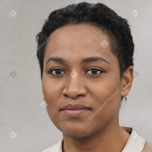 Joyful black young-adult female with short  black hair and brown eyes