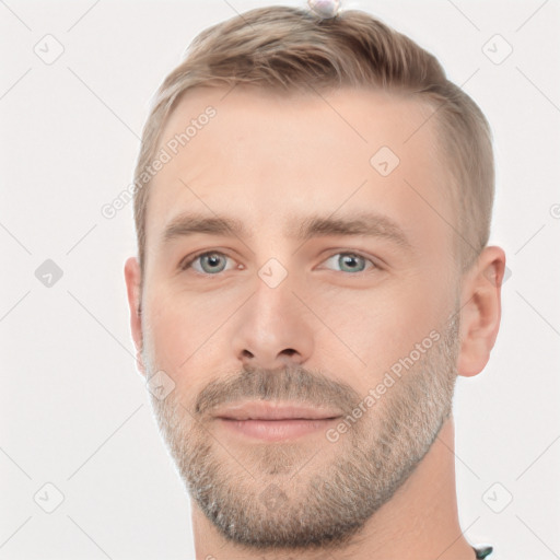 Joyful white young-adult male with short  brown hair and grey eyes