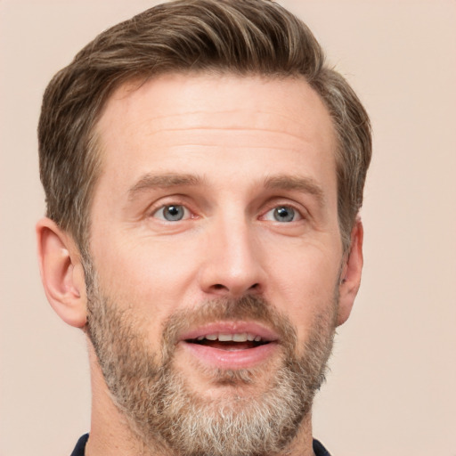 Joyful white adult male with short  brown hair and grey eyes