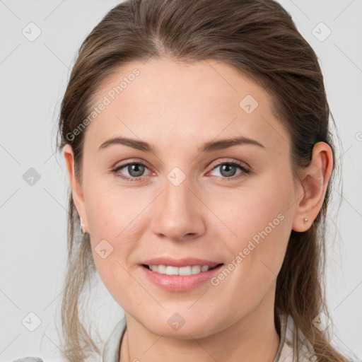 Joyful white young-adult female with medium  brown hair and grey eyes