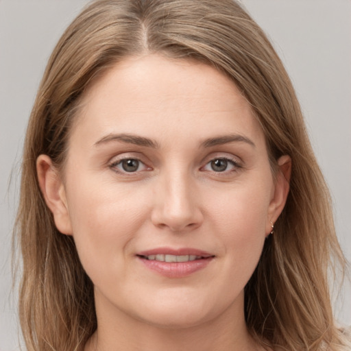 Joyful white young-adult female with long  brown hair and grey eyes