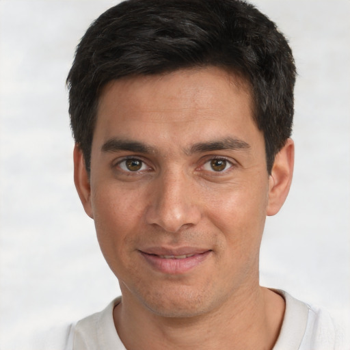 Joyful white young-adult male with short  black hair and brown eyes