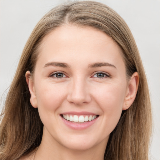 Joyful white young-adult female with long  brown hair and grey eyes