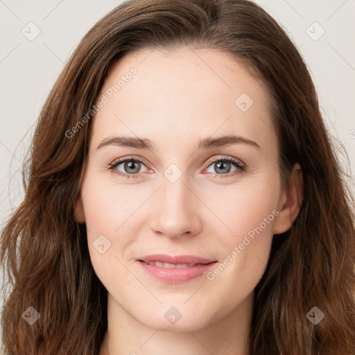 Joyful white young-adult female with long  brown hair and green eyes