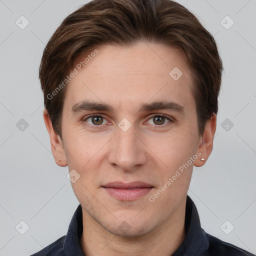 Joyful white young-adult male with short  brown hair and grey eyes