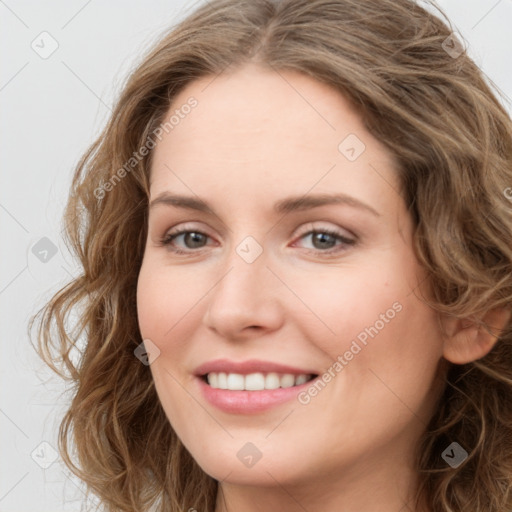 Joyful white young-adult female with long  brown hair and green eyes