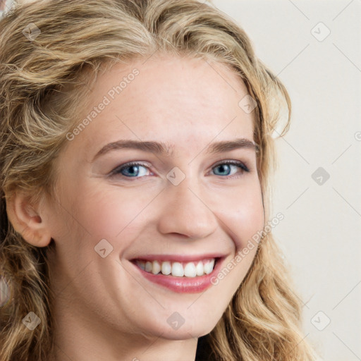 Joyful white young-adult female with long  brown hair and blue eyes