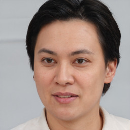 Joyful asian adult female with short  brown hair and brown eyes