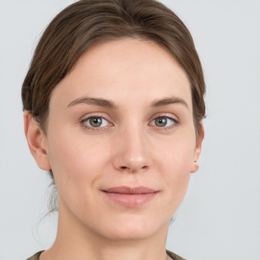 Joyful white young-adult female with medium  brown hair and grey eyes