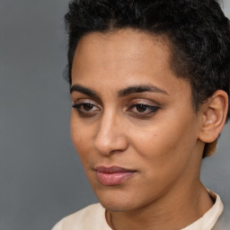 Joyful latino young-adult female with short  brown hair and brown eyes